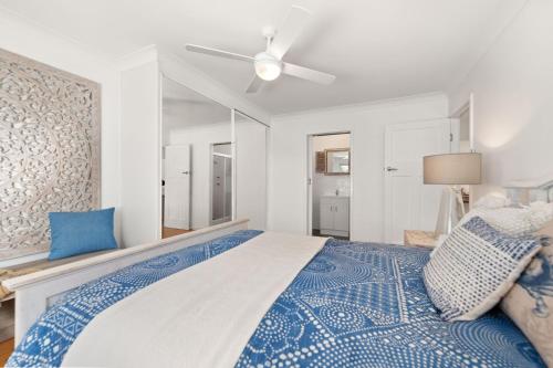 a bedroom with a bed and a ceiling fan at Gretel Cl 4 Nelson Bay in Nelson Bay