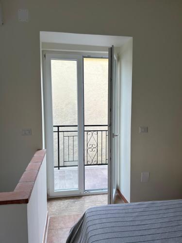 a bedroom with a door open to a balcony at Da Piero & Lilia in Centola