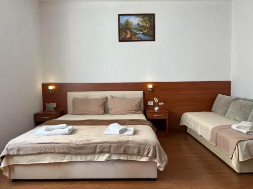 a bedroom with two beds with towels on them at Apartments Fat e Jet in Ulcinj