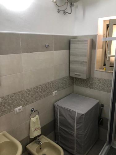 a bathroom with a sink and a toilet and a mirror at CASA DIANA in Lipari