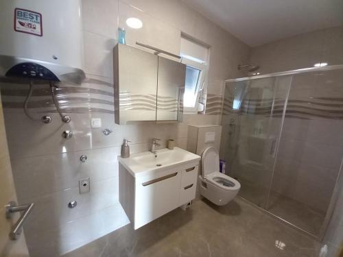 a bathroom with a sink and a shower and a toilet at Apartment ValMar in Vir