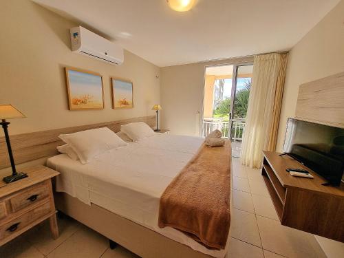 a bedroom with a large bed and a television at Atlantic Palace Family inn in Aquiraz