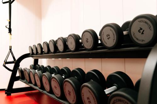 a row of dumbbells on a rack in a gym at Hotel Medistone in Omiš