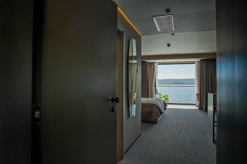 a room with a door with a view of the water at Hotel Medistone in Omiš