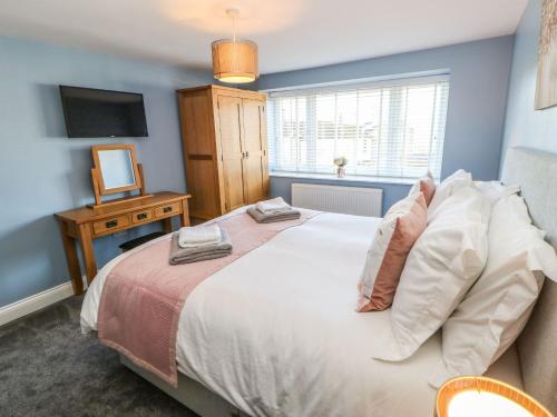 a bedroom with a large bed and a television at 15 Market Place in Barnard Castle