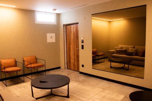 a waiting room with orange chairs and a mirror at Well Hotel & Spa in Maceira