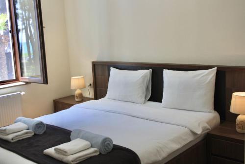 a bedroom with a large bed with towels on it at OXYGEN Shekvetili in Shekvetili