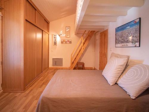 a bedroom with a bed in a room with a staircase at Appartement Valmorel, 4 pièces, 11 personnes - FR-1-291-749 in Valmorel