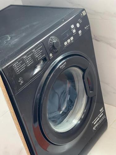 a black washing machine sitting on top of a counter at Étoile Harhoura in El Harhoura
