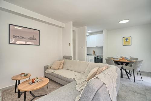 a living room with a couch and a table at Luxury apartments Meje near two beaches in Split