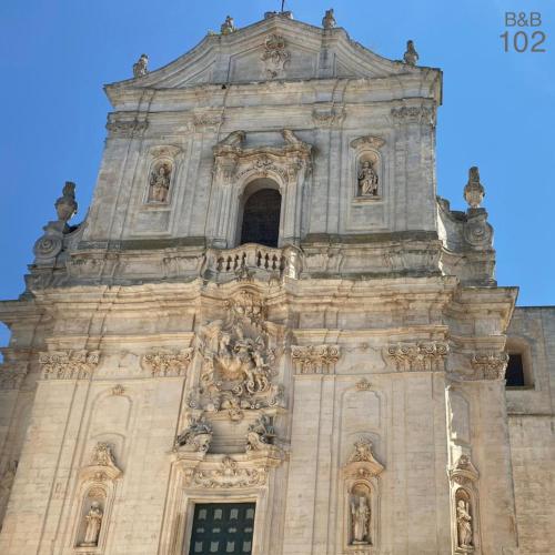 a tall tower with a statue on top of it at B&B 102 in Taranto