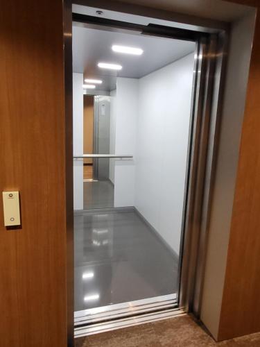 a sliding glass door in a room with a hallway at Apartament Bel Mare F 604 in Międzyzdroje