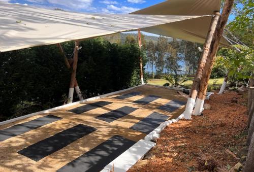 a large white tent on a concrete walkway at The Moorings Lakehouse in Whoota