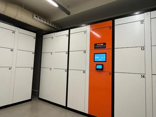 an orange and white vending machine in a locker room at Hotel Sagrada Familia in Barcelona