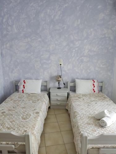 two beds sitting next to each other in a bedroom at Eva's Home in Skala Kallirakhis