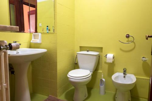 a bathroom with a white toilet and a sink at Casa vacanza Semia in Vinadio