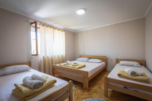 a room with two beds and a window at Guest House - Axios in Gevgelija