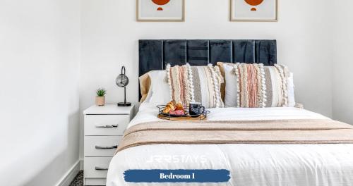 a bedroom with a bed with a black headboard at Dudley - Stylish 3 Bedroom Sleeps 6 Wi-Fi - JRR Stays in Woodside