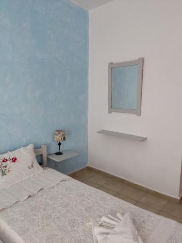 a bedroom with a bed and a table with a lamp at Eva's Home in Skala Kallirakhis