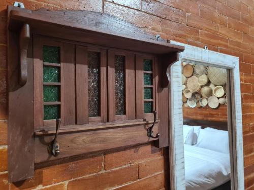 a mirror on a brick wall next to a window at La Tavisa Hotel Borobudur in Magelang