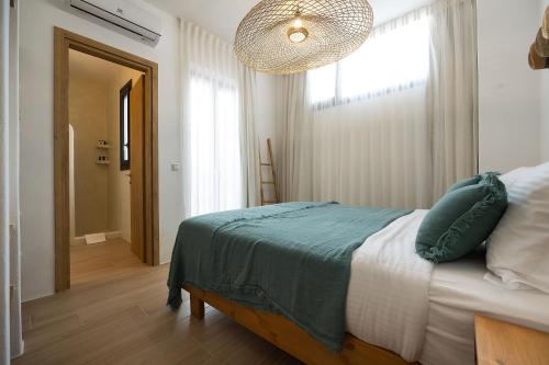 a bedroom with a bed and a large window at The Nine Graces - Kastraki Villas with Private Swimming Pool in Kastraki Naxou