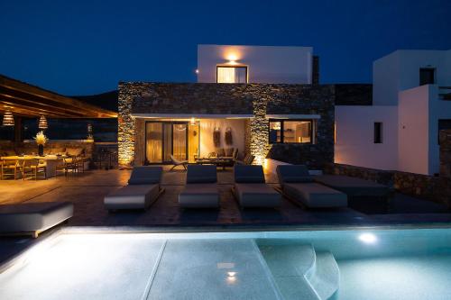 a villa with a swimming pool at night at The Nine Graces - Kastraki Villas with Private Swimming Pool in Kastraki Naxou