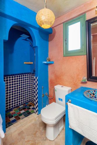 a blue bathroom with a toilet and a shower at Smile House Imlil in Imlil