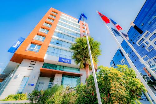 a tall building with flags in front of it at Kyriad Residence Casablanca in Casablanca