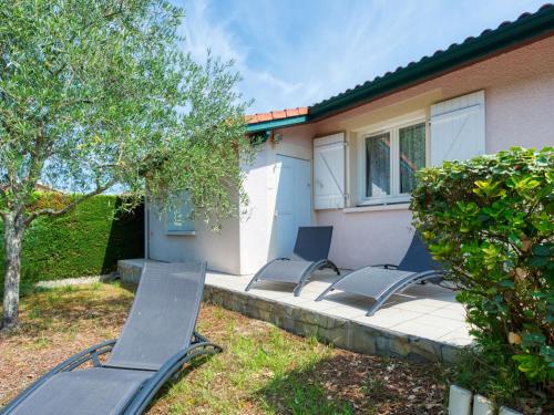 a group of chairs sitting on a patio in front of a house at Holiday Home Picasso by Interhome in Lacanau-Océan