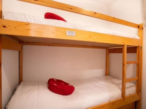 Litera con 2 almohadas rojas en la litera inferior en Apartment Les Asters-26 by Interhome en Les Menuires
