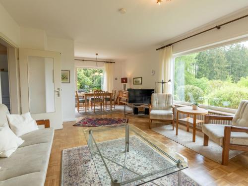 a living room with a couch and a table at Holiday Home Sonnenbühl by Interhome in Dittishausen