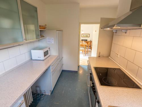 a kitchen with a sink and a microwave at Holiday Home Sonnenbühl by Interhome in Dittishausen