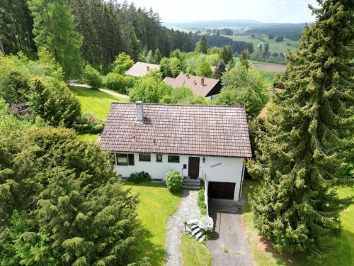 an aerial view of a white house in the forest at Holiday Home Sonnenbühl by Interhome in Dittishausen