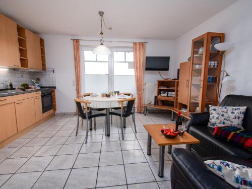 a living room with a table and a kitchen at Apartment Frisiastrasse-1 by Interhome in Norddeich