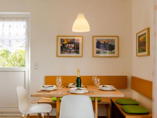 una sala da pranzo con tavolo e una bottiglia di vino di Holiday Home Hochwald by Interhome a Dittishausen