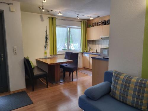 a kitchen and living room with a table and chairs at Apartment Michael by Interhome in Kappl