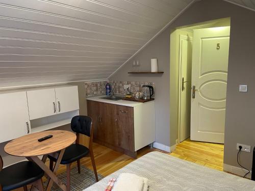 a small kitchen with a table and a table and chairs at Mimoza Guesthouse in Istanbul