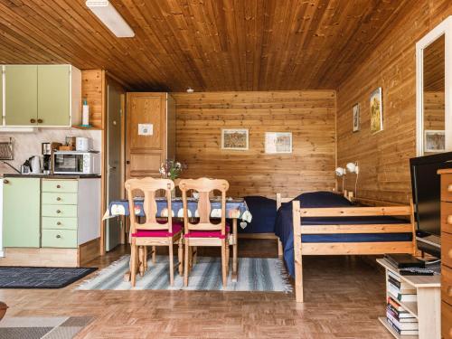 a kitchen and a dining room with a table and chairs at Holiday Home Tingsmåla by Interhome in Tingsryd