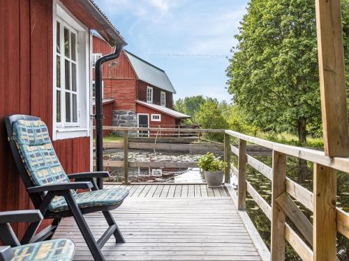 une terrasse avec une chaise et une grange rouge dans l'établissement Holiday Home Tingsmåla by Interhome, à Tingsryd