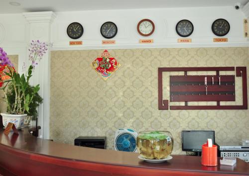 a room with clocks on the wall and a desk at Tan Duy Hotel in Xuyên Mộc