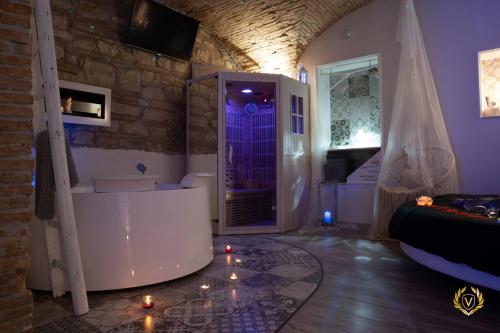 a bathroom with a tub and a walk in shower at VenuSuite VENOSA - Luxury House, Spa & Relax - in Venosa
