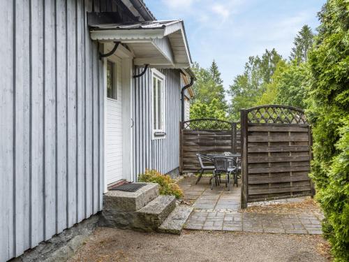 a patio with a table and a fence next to a house at Holiday Home Forneboda by Interhome in Kyrkhult