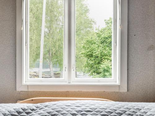 a window in a bedroom with a bed in front of it at Holiday Home Forneboda by Interhome in Kyrkhult