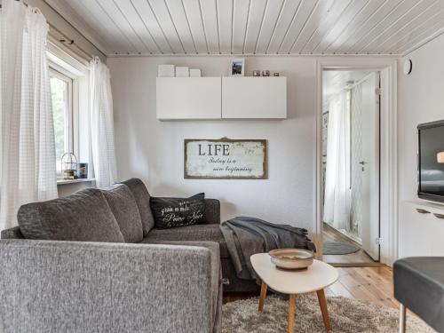 a living room with a couch and a table at Chalet Ringsegård Höjden - HAL045 by Interhome in Falkenberg