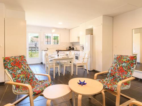 a kitchen and dining room with chairs and a table at Holiday Home La Lette II Albizzias by Interhome in Saint-Julien-en-Born