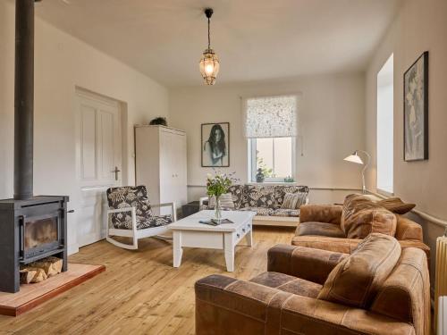 a living room with a couch and a fireplace at Villa Svoboda na Úpou by Interhome in Svoboda nad Úpou