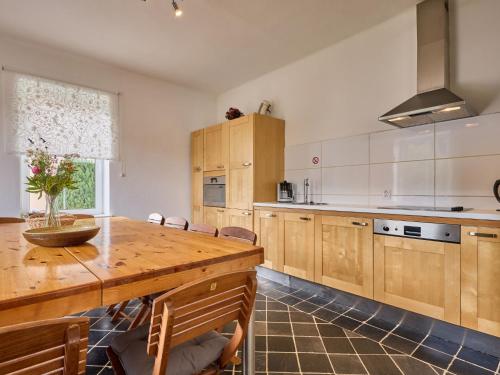 a large kitchen with a wooden table and chairs at Villa Svoboda na Úpou by Interhome in Svoboda nad Úpou