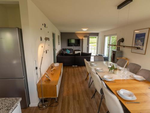 a dining room with a long table and a kitchen at Holiday Home Schwarzwald by Interhome in Dittishausen