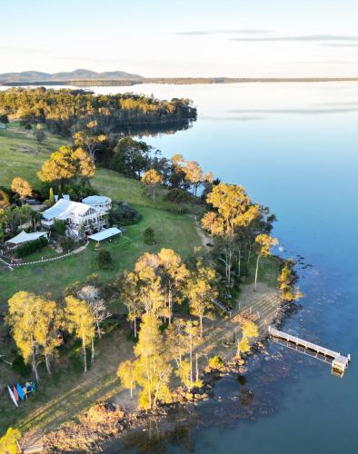 an aerial view of a house on an island in the water at The Moorings Lakehouse in Whoota