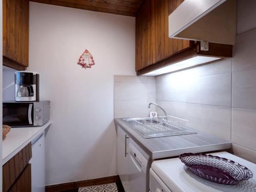 a small kitchen with a sink and a dishwasher at Studio Le Bionnassay by Interhome in Les Contamines-Montjoie